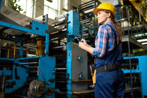 Woman surveying work in a manufacturing plant
