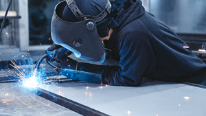 A person welding with sparks flying