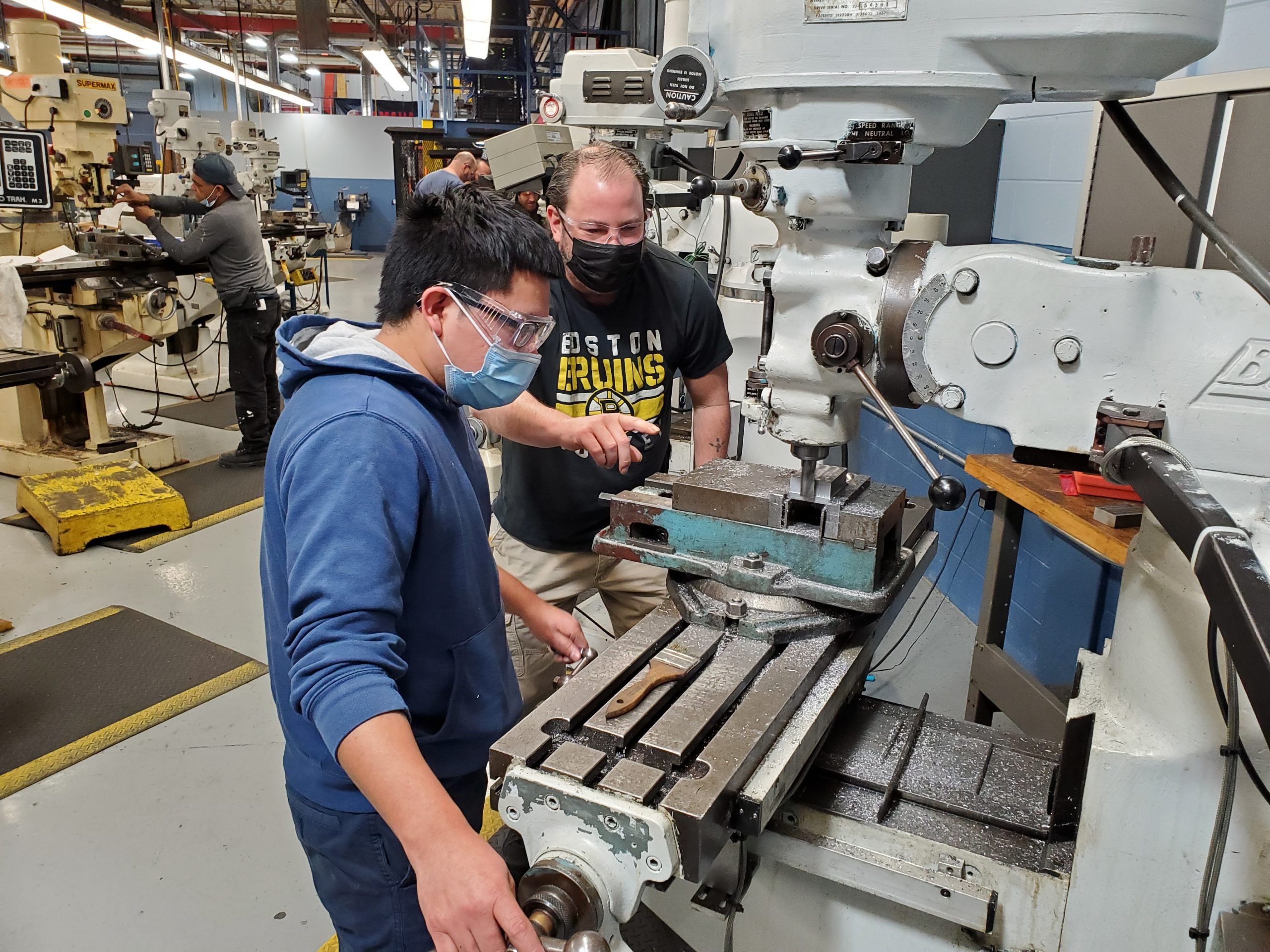 Advance Manufacturing student working on machine with instructor